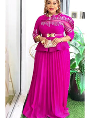 A woman wears a long, fuchsia-colored dress with a peplum waist, pleated skirt, and beaded detail.