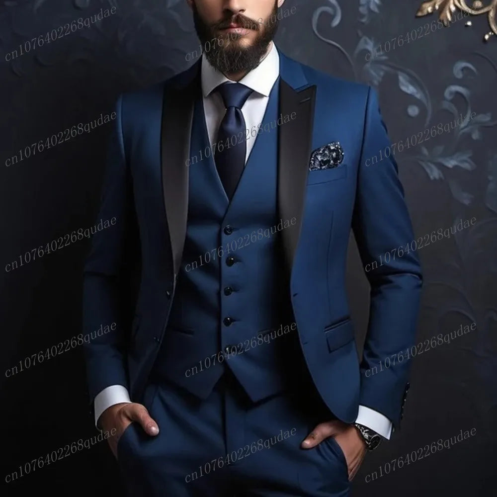 A man wears a three-piece blue suit with a black shawl collar, white shirt, and dark tie.