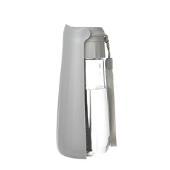 A gray portable dog water bottle with a clear reservoir and an attached carrying lanyard.