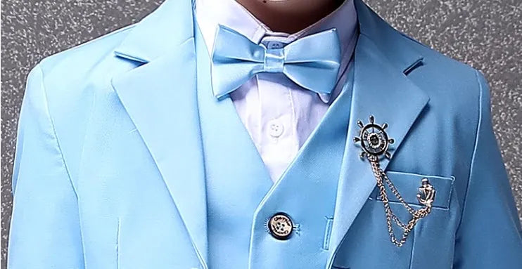 A sky blue formal suit for children featuring a matching bow tie and a ship wheel lapel pin.