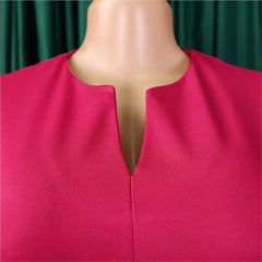 A close-up view of a magenta dress featuring a V-neckline on a mannequin.