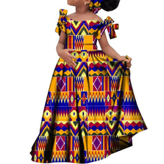 A girl wears a long, off-the-shoulder African print dress with a matching headscarf.