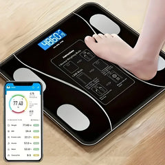 A black digital body scale with a backlit LED display and a smartphone showing health metrics.