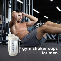 A beige protein shaker bottle with a carrying strap sits in front of a man doing sit-ups.
