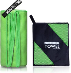 A folded green microfiber towel next to its black and green mesh carrying pouch.