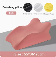 A pink memory foam prone position pillow with a contoured shape measuring 55 by 36 by 23 centimeters.