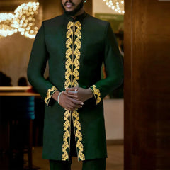 A man wears a dark green long-sleeve tunic with gold floral embroidery and matching trousers.