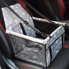 A grey pet car seat with a paw and bone pattern, featuring mesh sides and adjustable straps.
