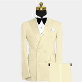 A cream-colored double-breasted suit with a peak lapel, white shirt, and black bow tie.