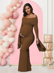 A pregnant woman wears a brown off-shoulder long-sleeve mermaid dress with flared cuffs.