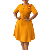A mustard yellow A-line knee-length dress with short sleeves, a round neckline, and button detail.