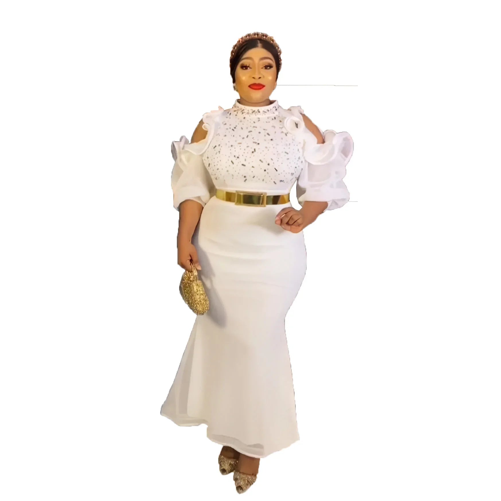 A woman wears a white, ankle-length, cold-shoulder evening dress with a sparkly high neckline.