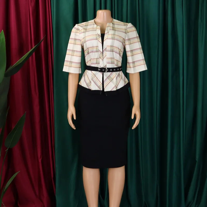 A woman wears a plaid V-neck half-sleeve top with a black belt and a matching black pencil skirt.