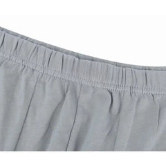 Close-up of the grey elastic waistband on a pair of plus-size cotton boxer briefs.