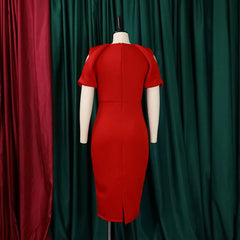 A red, mid-calf sheath dress with cold-shoulder sleeves and an O-neck on a mannequin.
