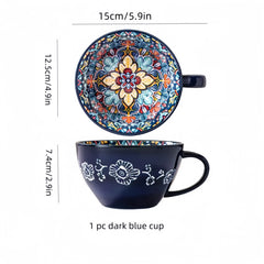 A dark blue ceramic tea mug featuring a vibrant, colorful bohemian floral pattern inside.