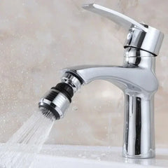 A chrome faucet aerator attachment with a swivel nozzle spraying water into a sink.