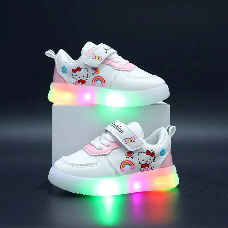 A pair of white Hello Kitty sneakers for girls with light-up soles and hook and loop closures.