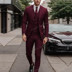 A man wears a burgundy three-piece suit consisting of a jacket, vest, and trousers.