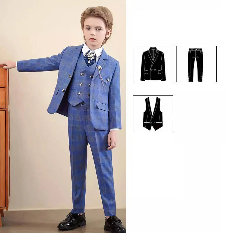 A boy wears a blue plaid three-piece suit with a white shirt and a decorative brooch.