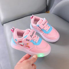 A pair of pink Hello Kitty sneakers for girls featuring light-up soles and hook-and-loop straps.