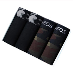 A set of four men's boxer shorts in solid black and camouflage patterns inside a box.