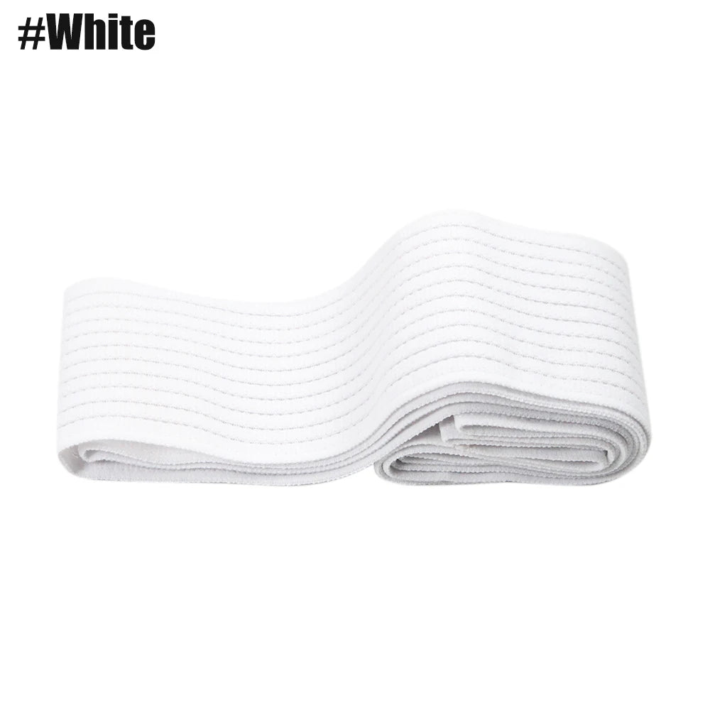 A white elastic compression bandage is folded and laid flat against a white background.