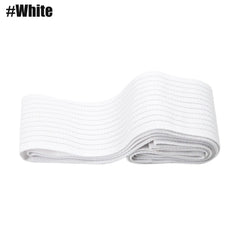 A white elastic compression bandage is folded and laid flat against a white background.