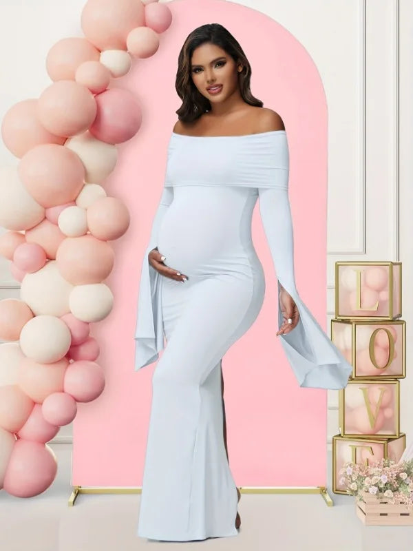 A pregnant woman wears a light blue off-shoulder long-sleeve mermaid maternity dress.