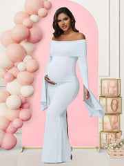 A pregnant woman wears a light blue off-shoulder long-sleeve mermaid maternity dress.