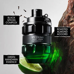 A bottle of Viktor and Rolf Spicebomb Nightvision cologne sits next to a lime and tree bark.