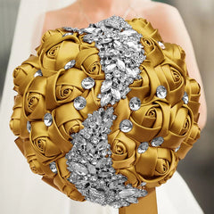 A gold silk rose wedding bouquet accented with a central strip of sparkling silver crystals.