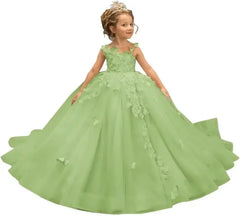A young girl wears a floor-length, light green tulle ball gown with 3D butterfly appliques.