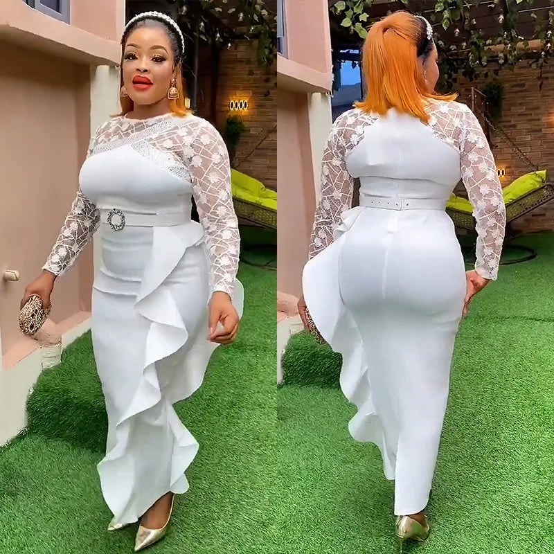 A woman wears a white long-sleeve midi dress with lace sleeves, a belted waist, and side ruffles.
