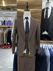 A brown plaid three-piece slim fit suit with a white shirt and a striped tie on a mannequin.