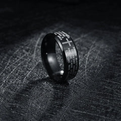 A black stainless steel ring engraved with the Lord's Prayer in Spanish and a central cross.