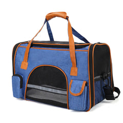 A blue, soft-sided pet carrier with brown trim, mesh windows, and a top handle.