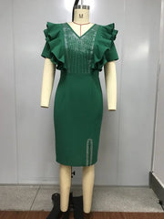 A dark green sheath dress with a V-neck, petal sleeves, and crystal embellishments.