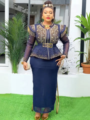 A woman wears a navy blue two-piece set featuring a beaded peplum top with fringe and a long skirt.