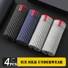 Four pairs of striped men's boxer shorts with red waistbands arranged on a black surface.
