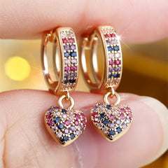 Gold hoop earrings featuring heart-shaped pendants encrusted with multicolored cubic zirconia.