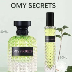 Two glass perfume bottles with textured surfaces and black caps labeled OMY SECRETS.