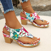 Women's white floral print thong sandals with a chunky heel and buckle strap closure.