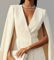 A white double-breasted mini dress with a V-neck and cape sleeves.