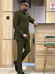 A man wears an olive green slim-fit suit with a unique asymmetrical button-down jacket.