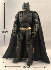 A 33cm tall Batman action figure with a black suit, gold utility belt, and fabric cape.