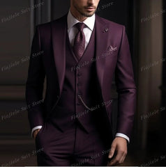 A man wears a dark purple three-piece suit with a matching vest, tie, and pocket square.