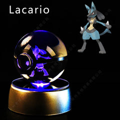 A Lucario figure is laser-etched inside a glass Pokeball sphere resting on an illuminated base.