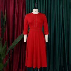 A red mid-calf A-line dress with an O-neck and three-quarter sleeves on a mannequin.