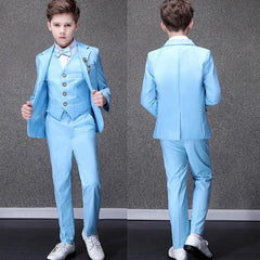 A boy wears a sky blue formal suit featuring a blazer, vest, trousers, and a matching bow tie.